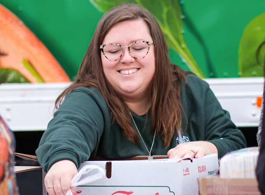 A Second Harvest Employee handing out food