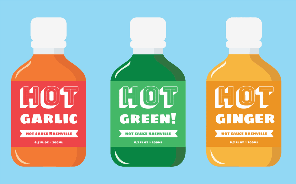 Three bottles of hot sauce on a blue background. The bottles are labeled Hot Garlic (orange), Hot Green! (green), and Hot Ginger (yellow), each with Hot Sauce Nashville written below the flavor name.