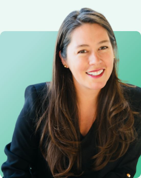 A woman with long brown hair wearing a black blazer smiles at the camera against a green gradient background with rounded corners.